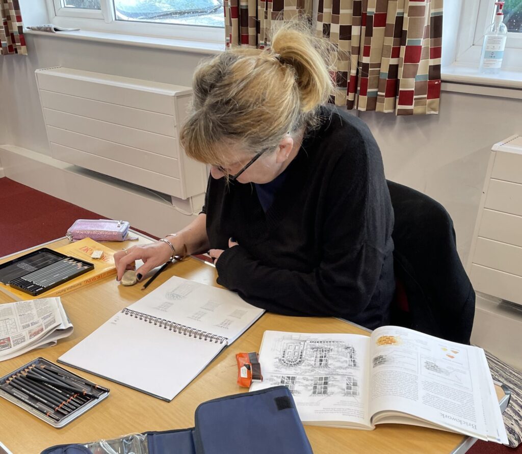 Group member engrossed in sketching